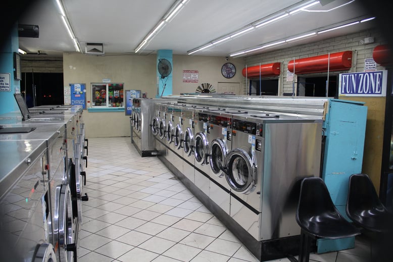 a row of washing machines in a laundry room