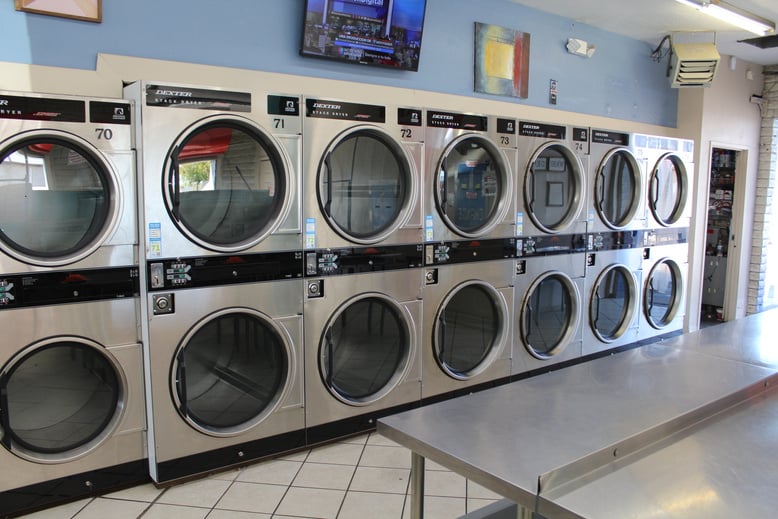 a row of washing machines in a laundry room