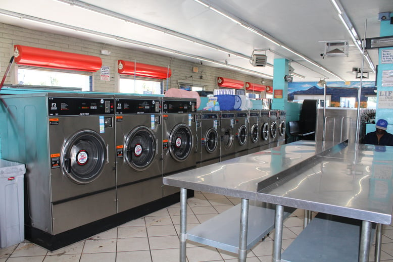 a row of washing machines in a laundromat